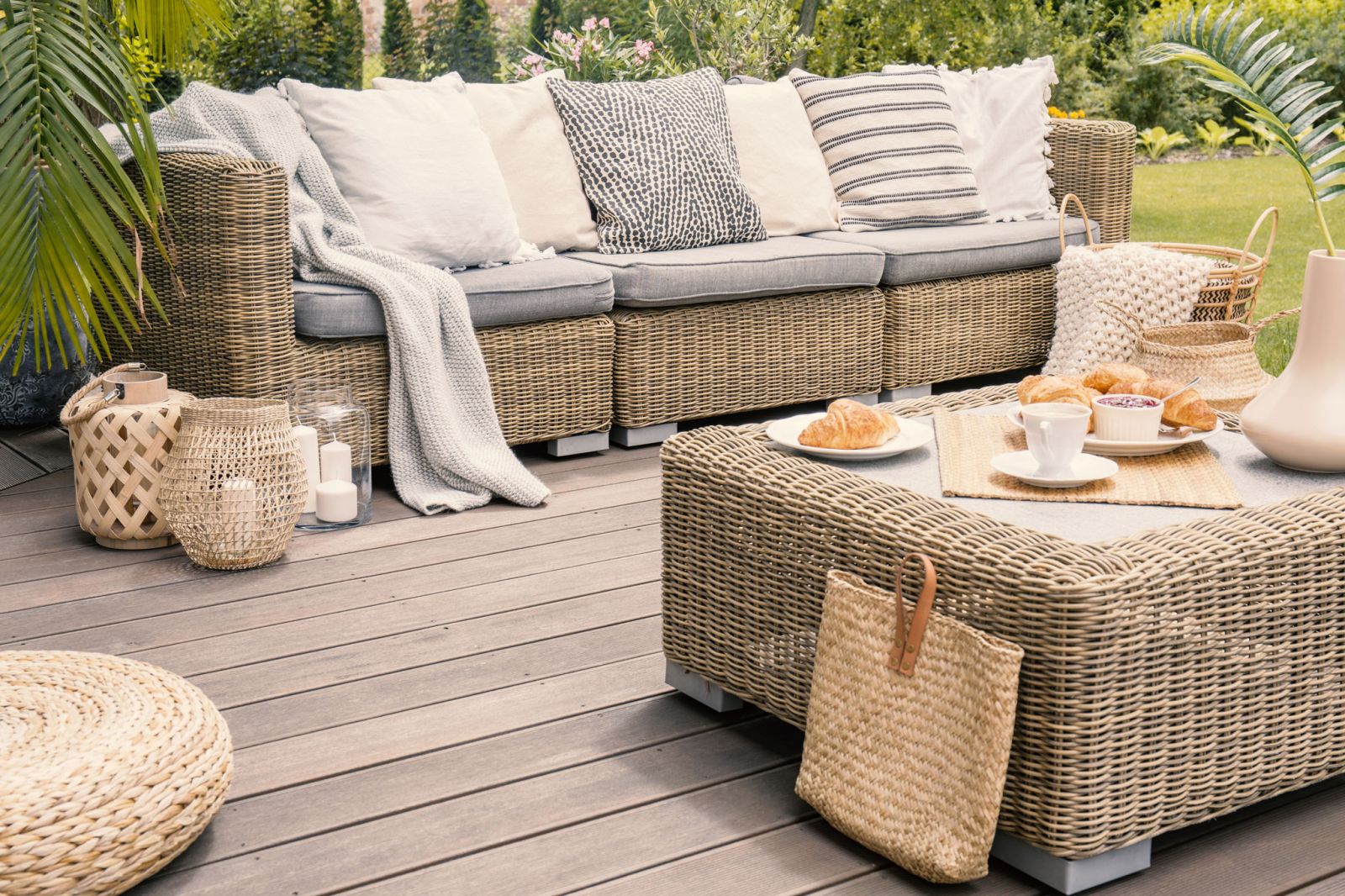 a brown decking with garden furniture on top