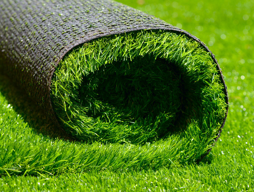 a roll of artificial turf being laid